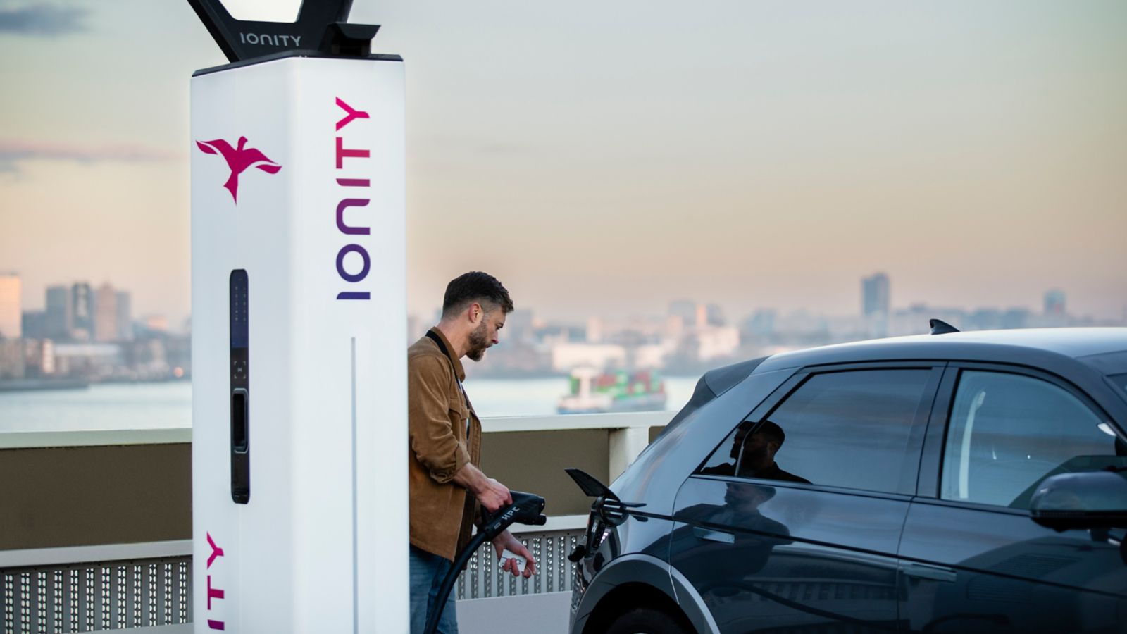 A man charging his Hyundai IONIQ.